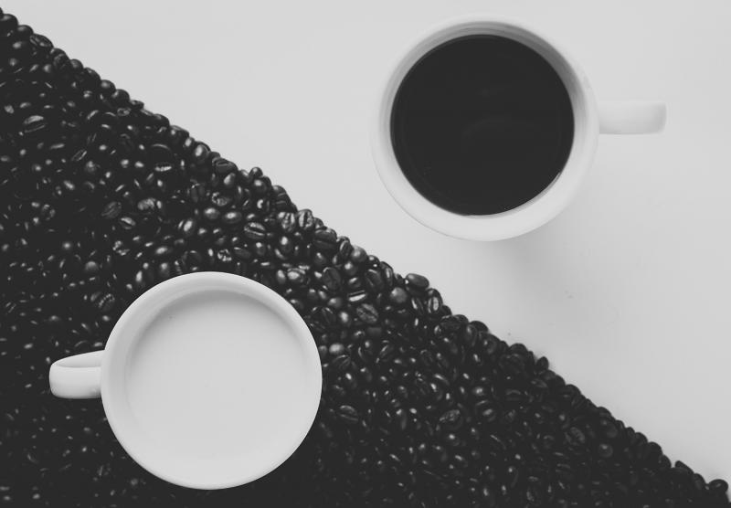 Banner 1500x1000 alex 6723 unsplash coffee cup on white background and milk cup on black background (coffee beans)
