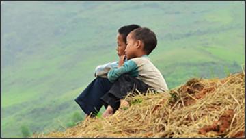 Illustration 560x315 vie two young boys sitting on a stack of hay looking into distance